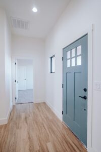 Clean and inviting entryway with a stylish door and wooden floors, maintained by Lucky Locals, reflecting the high standards of house cleaning services in Las Vegas NV